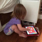 Baby looking at tablet screen — screen time guidelines from Spring Valley Pediatrics Washington DC